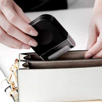 Handheld fabric shaver removing lint from a grey sweater.