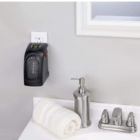 Mini plug-in heater securely plugged into a wall socket for instant heat.