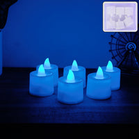 Blue LED Tea Light Candle glowing brightly in dark setting