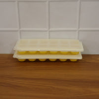Easy release silicone ice cube maker with 24 compartments and lid.