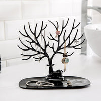 Side view of deer shaped jewellery holder showcasing antler branches and oval tray