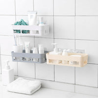 Wall-mounted shower shelf neatly holds toiletries in a bathroom corner.