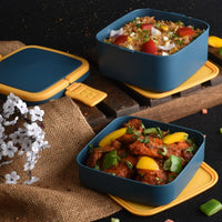 Close-up of the blue stackable lunch box with its sturdy carrying handle.