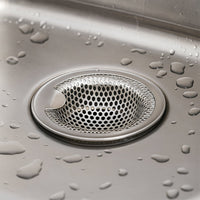 Stainless steel catcher strainer placed in kitchen sink drain opening