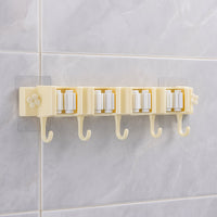 Self-adhesive broom and mop holder rack mounted on wall with utility hooks