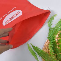 Compact red drawstring bag folded, ideal for space-saving storage.