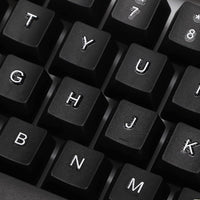 Angled view of the wired keyboard, highlighting its full-size layout and ergonomic key placement.