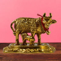 Sacred metal Kamdhenu Cow and calf idol in golden finish