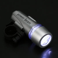 Bright LED bicycle headlight securely mounted on a bike handlebar.