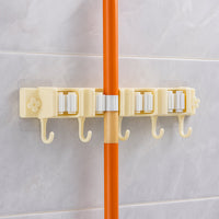 Close-up image of broom holder's multi-roller grip system on wall