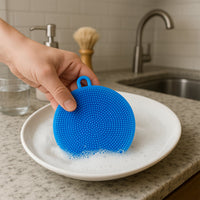 Top-down view of the ergonomic, circular silicone dish scrubber.