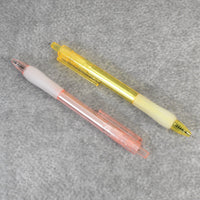 A pair of CustoPen ballpoint pens displayed with essential office stationery.
