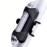 Rechargeable LED bicycle light with USB charging port for convenient power.