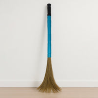 Close-up view of floor broom head with synthetic bristles