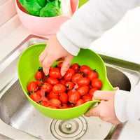 A Quickslice rice washing bowl with a thick drain basket and handle, perfect for kitchen use.