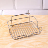 Metal soap holder exhibiting open drain bars to prevent soap mushiness