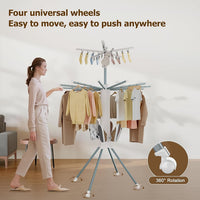 Clothes drying rack in use with multiple hanging garments drying