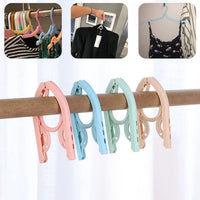 Space-saving foldable travel hanger designed to keep clothes wrinkle-free