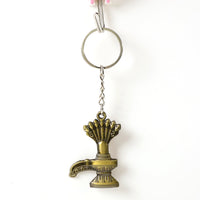 Close-up of Lord Shiva Shivaling metal keychain with detailed serpent design