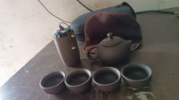 Tea set with teapot, cups & accessories on a wooden tray for travel or home