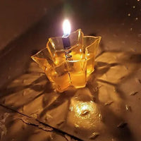 Several unlit reflection diyas neatly stacked, highlighting their golden finish and intricate details.