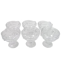 Variety of desserts like parfaits and sundaes beautifully presented in glass serving cups.