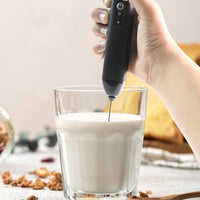 Closeup of stainless steel whisk on electric handheld milk frother