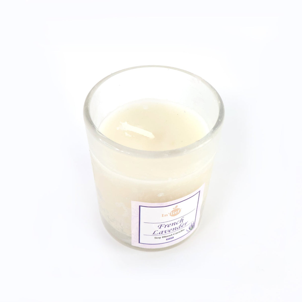 Top view of French Lavender soy candle glowing with warm flame