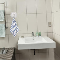 Strong plastic suction cup hook supporting towel on bathroom wall