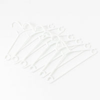 Stack of 6 white plastic clothes hangers ready for use