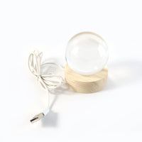 Warm glow from the 3D Crystal Ball Lamp creating a serene ambiance in a dark room.