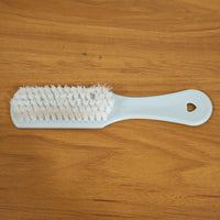 Close-up of ergonomic handle and bristles on handheld cleaning brush