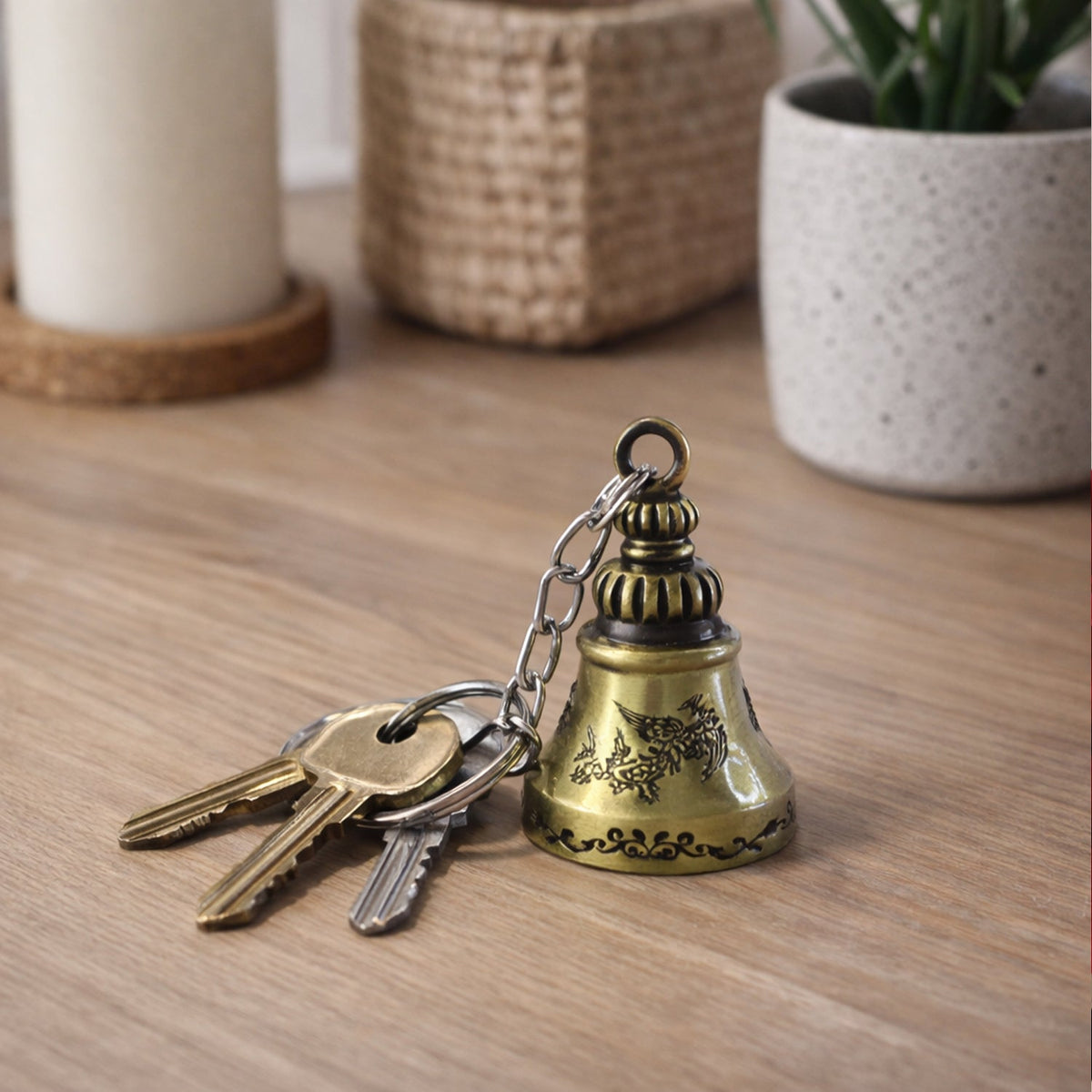 Close-up of the small ringing temple bell on the metal keychain, emphasizing detail.