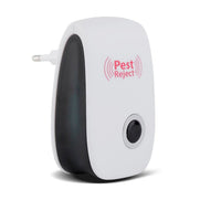 A white and black pest repeller with a black button and silver ring is shown on a white background.