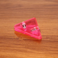 Triangle paper clips securing book pages efficiently