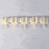 Close-up of self-adhesive broom holder rack mounted on home wall