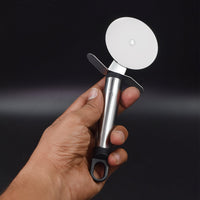 Wheel-type pastry and pizza slicer with a protective thumb guard.
