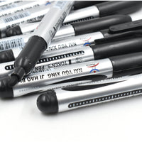 Hand holding an InkGlow Permanent Black Marker for smooth writing.