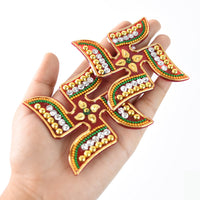 Swastik symbol sticker highlighted with red-orange and gold detailing