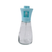 Transparent glass oil sprayer bottle showcasing its durable plastic top and sleek design.