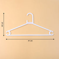 White plastic clothes hanger supporting a hanging garment