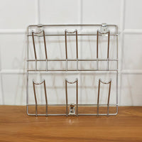 Close-up of stainless steel wall-mounted mug and cup holder rack