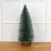 Miniature green Christmas tree with snow effect and sturdy wooden base for festive decor