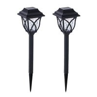 FitFuzion solar pathway lights casting bright, artistic patterns on a dark garden path, enhancing outdoor decor.