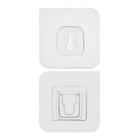 Two white no-drill adhesive hooks mounted on a smooth, clean wall surface.