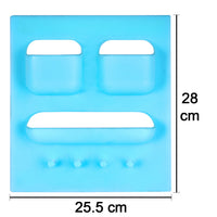 Compact self-adhesive bathroom shelf holding soap, toothbrushes, and other small items.
