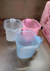 Stylish Transparent Bath Mug displayed in a modern bathroom setting.