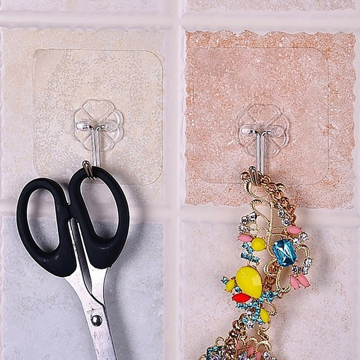 The full 100-pack of multipurpose stainless steel adhesive wall hooks, ready for use.
