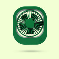 Rechargeable travel fan standing on a surface, highlighting its compact design.