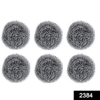 Heavy-duty stainless steel scrubber tackling tough grease on utensils.
